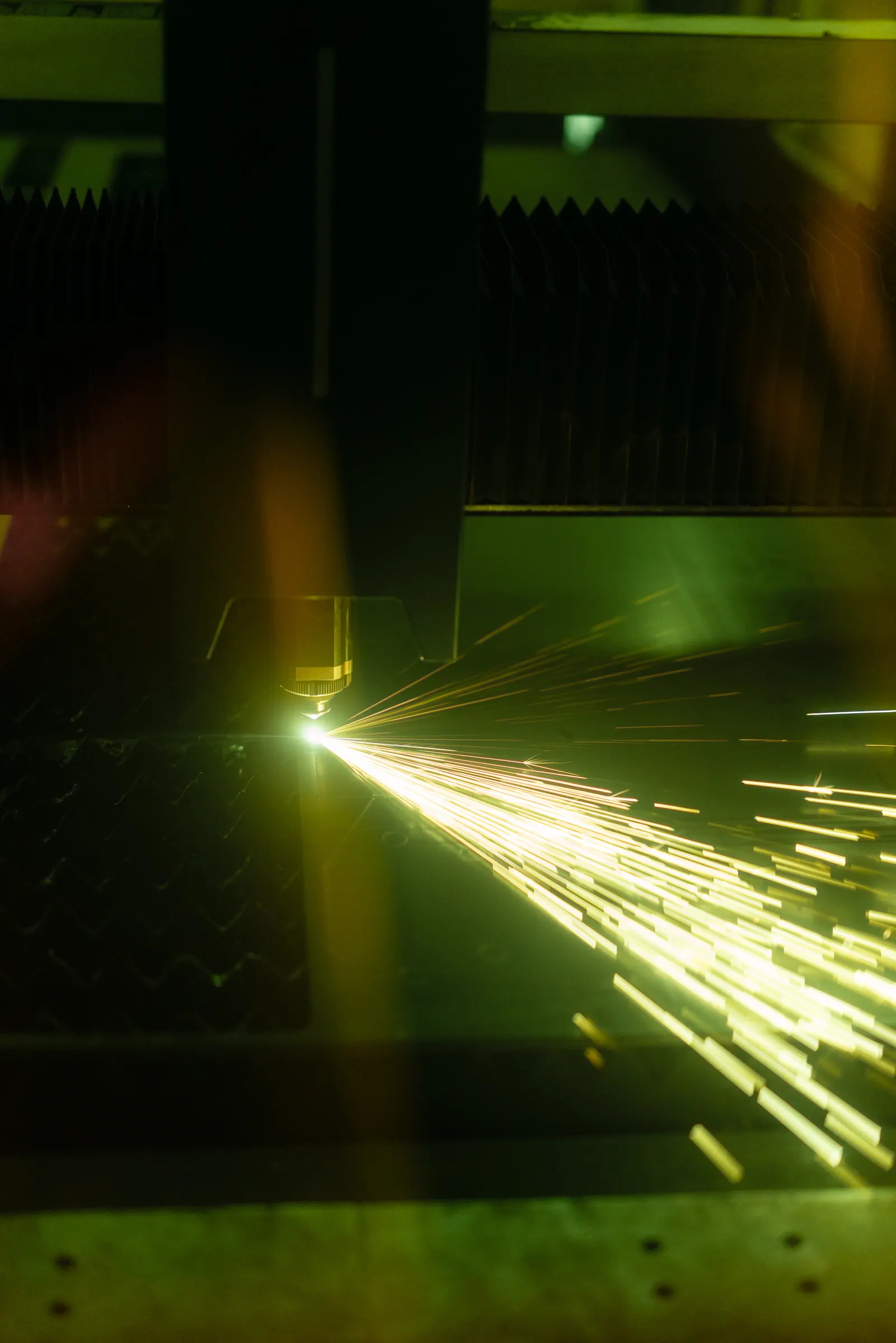 Laser cutting steel plate with a shower of sparks