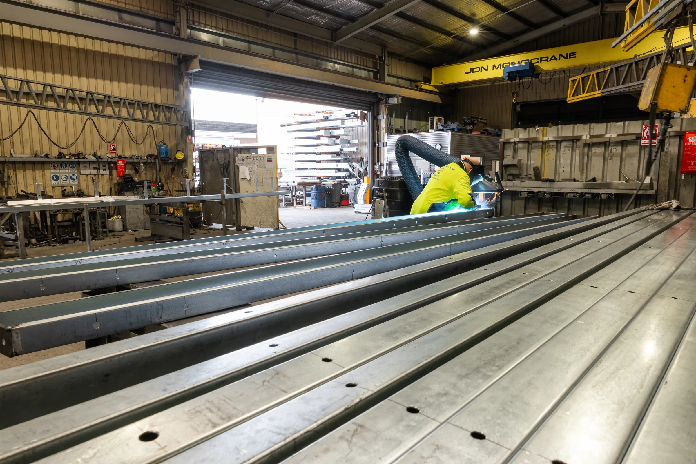 Steel lengths beneath the overhead gantry crane