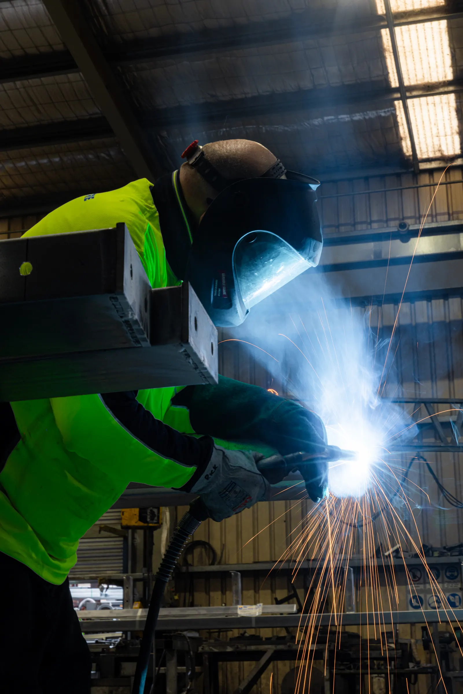 Welder fabricating a steel frame