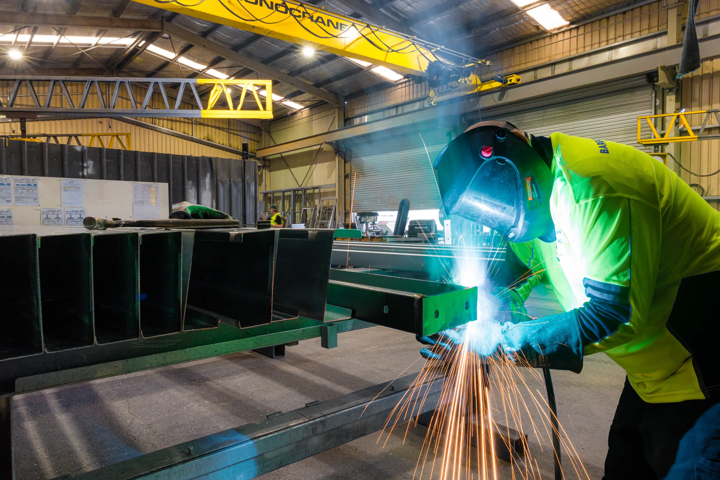 Welder fabricating with sparks flying